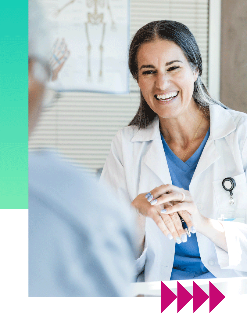 female-doctor-smiling-with-patient Female doctor holding patient hand and smiling