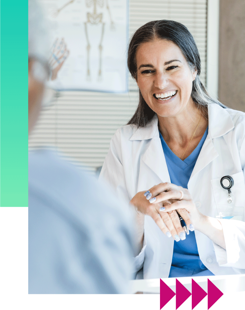 Female doctor holding patient hand and smiling