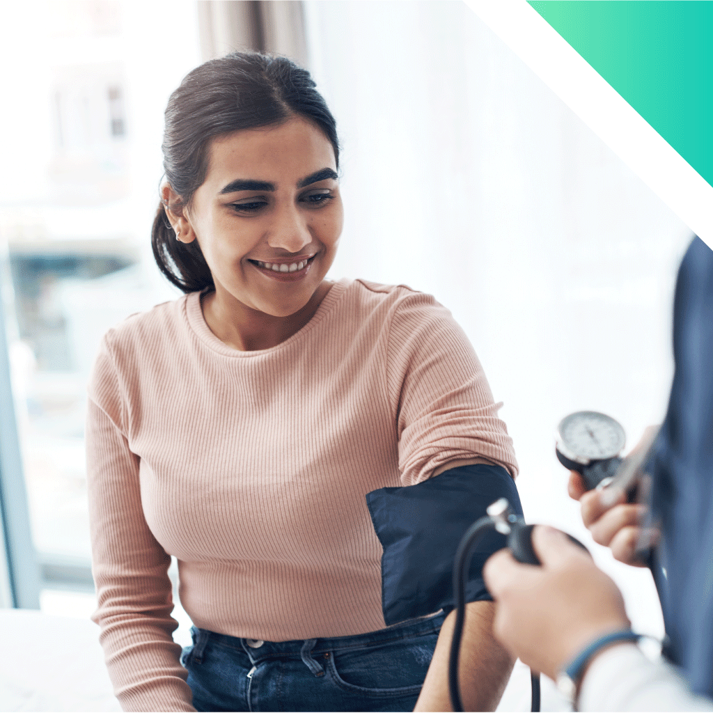 provider taking womans blood pressure